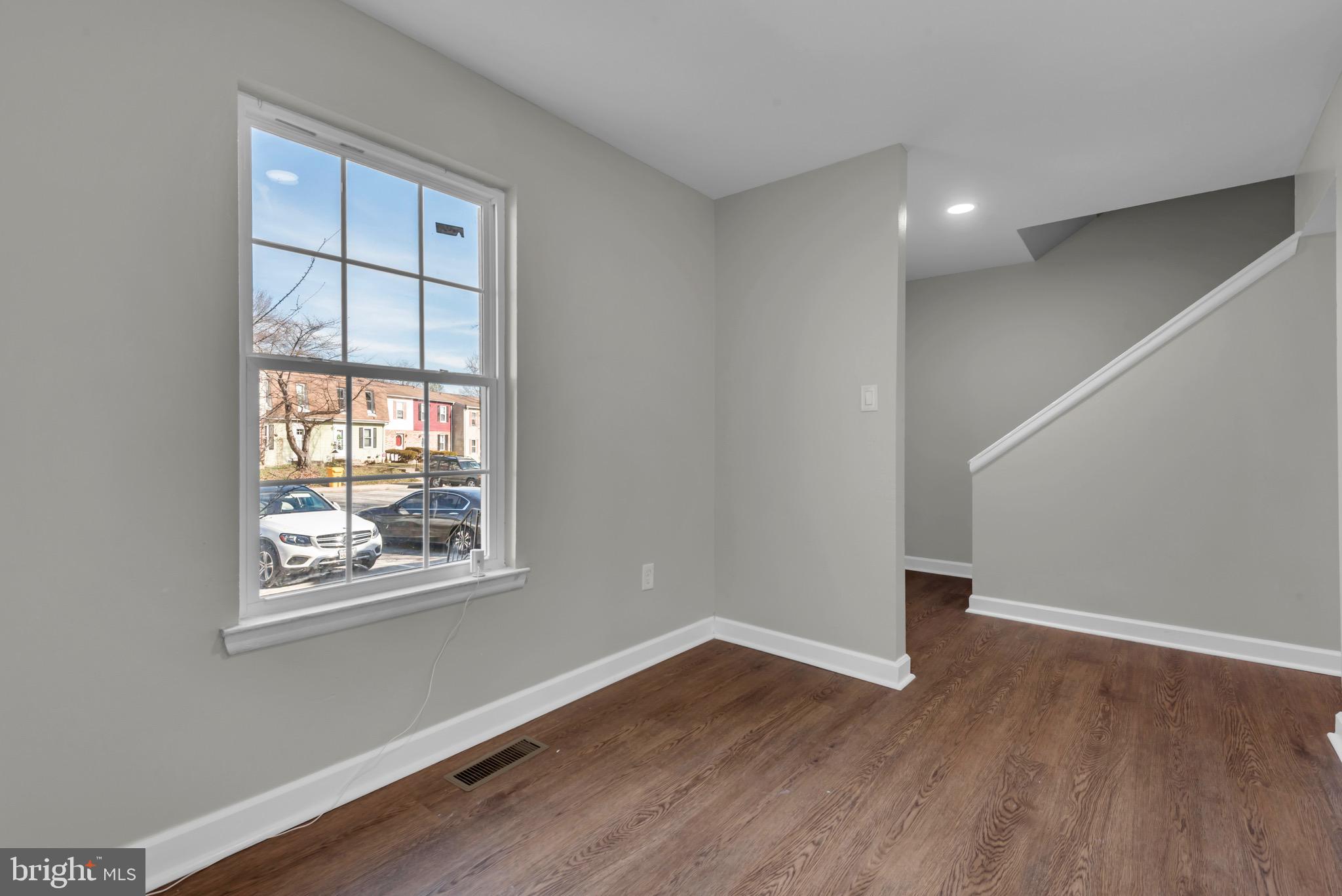 1869 Robin Court Severn, MD 21144 - Photo 7 of 43 a view of an empty room with wooden floor and a window