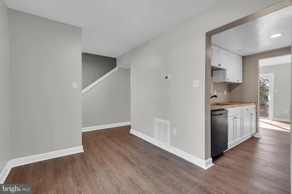 a kitchen with granite countertop a sink and a stove top oven