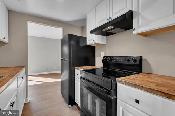 a kitchen with a stove microwave and refrigerator