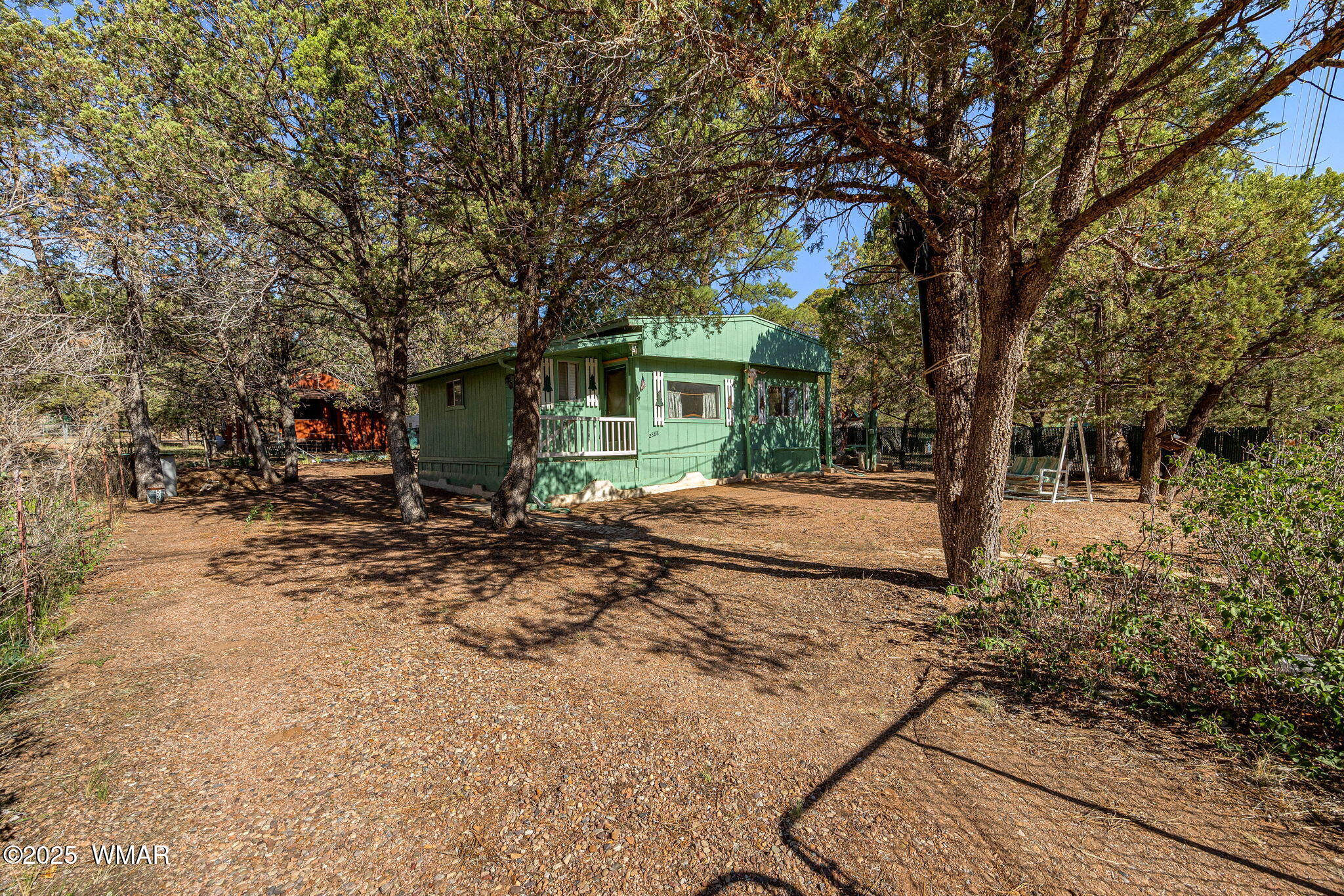2888 Dale Road Overgaard, AZ 85933 - Photo 17 of 31 a backyard of a house with barbeque oven table and chairs