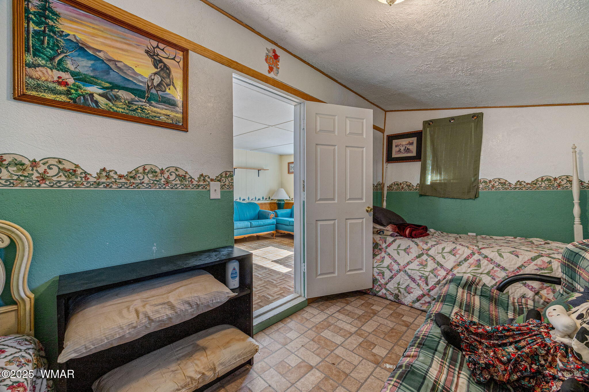 2888 Dale Road Overgaard, AZ 85933 - Photo 8 of 31 a bed sitting in a bedroom next to a window with potted plants