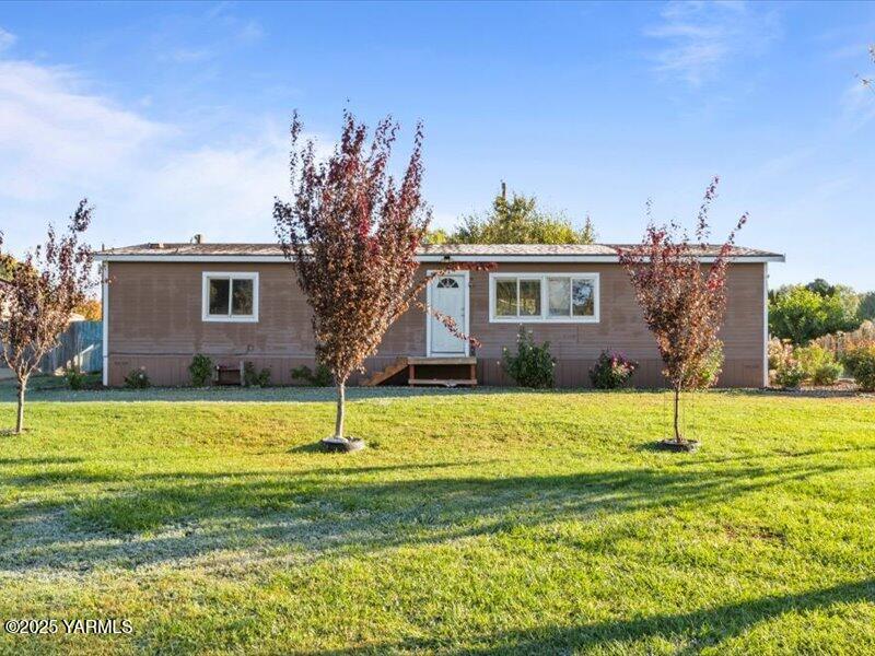 a house with a big yard and large trees