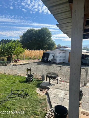 a view of a house with a big yard and palm trees