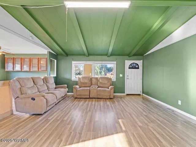 a kitchen with stainless steel appliances kitchen island granite countertop a refrigerator and a stove