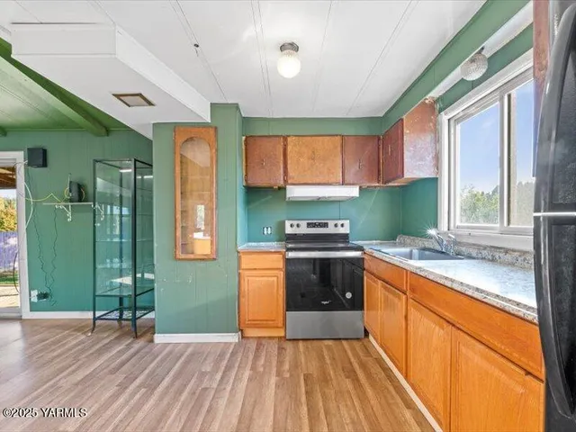 a room with a window and wooden floors