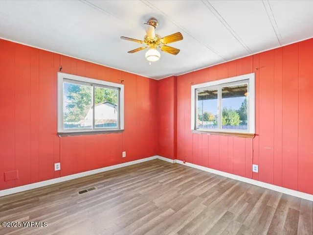 wooden floor in an empty room with a window