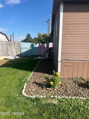 a view of a big yard with a house in the background