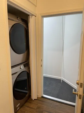 a view of a hallway with washer and dryer
