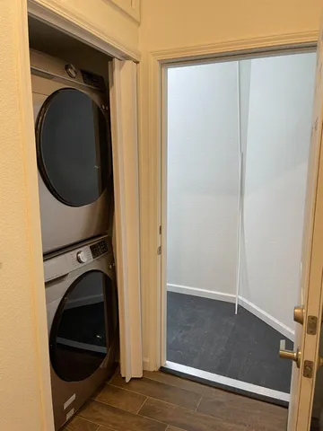 a view of a hallway with washer and dryer