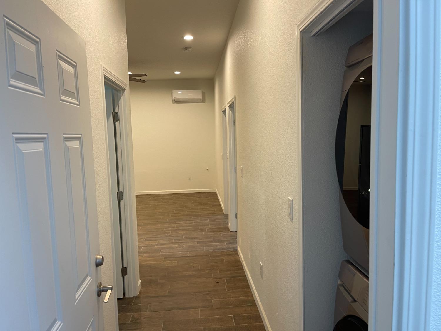 217 5th Street, Unit C Colusa, CA 95932 - Photo 5 of 13 a view of a hallway with wooden floor and cabinets