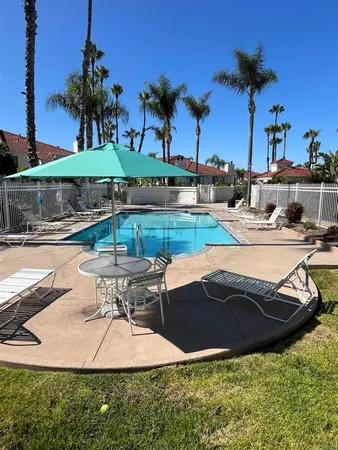 a view of swimming pool with outdoor seating and plants