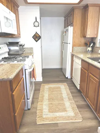 a kitchen with a refrigerator sink stove and refrigerator