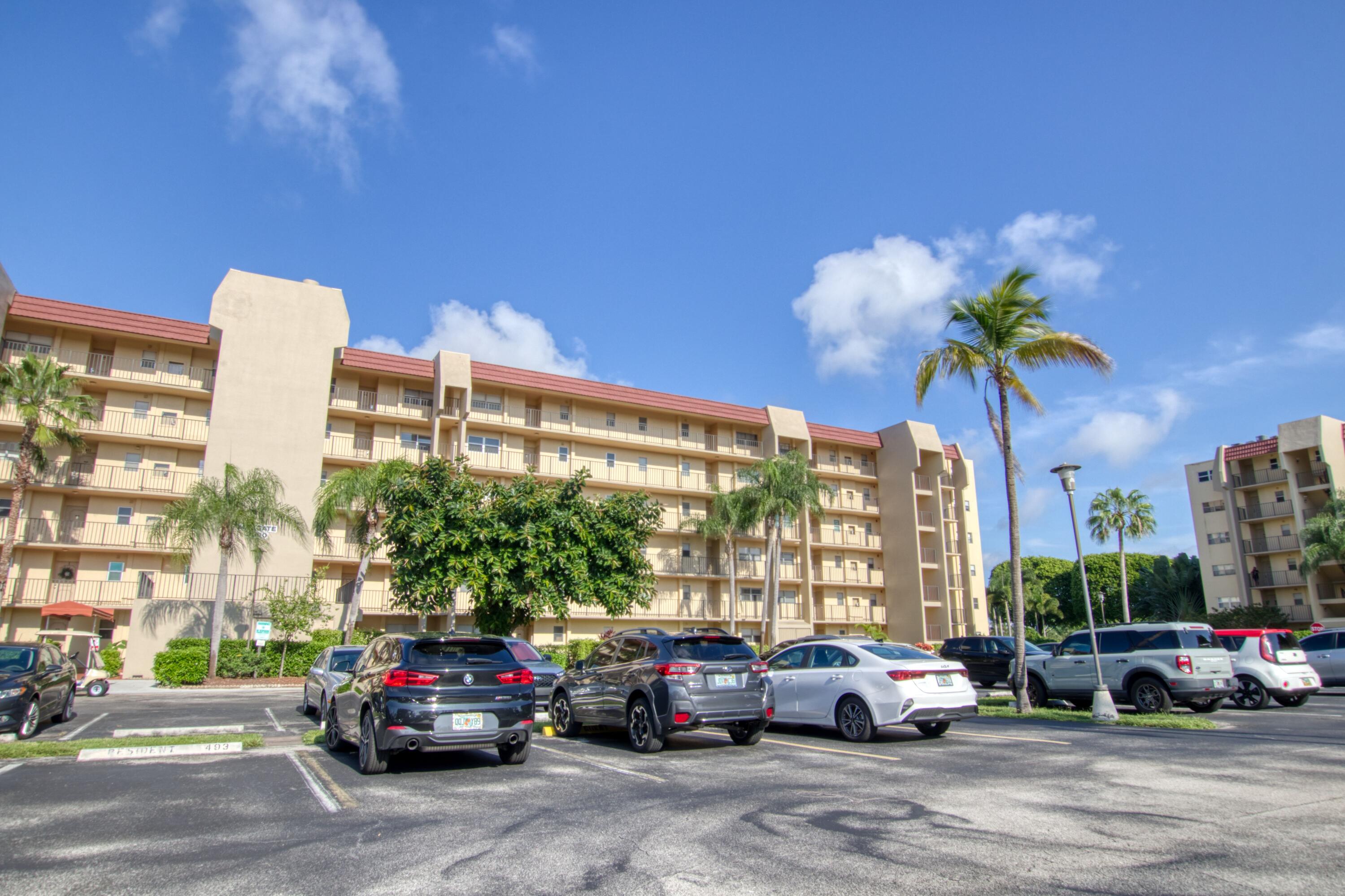 3590 Via Poinciana, Unit 614 Lake Worth, FL 33467 - Photo 2 of 20 a cars parked in front of a building