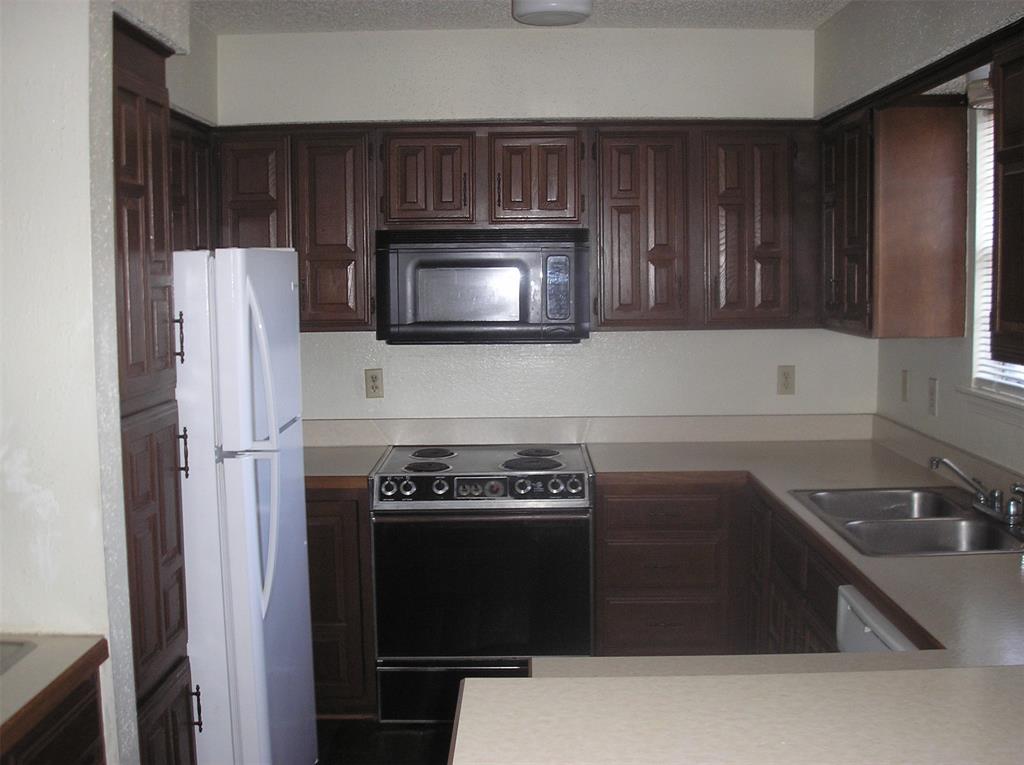 2310 Melissa Drive Waco, TX 76708 - Photo 4 of 10 a kitchen with cabinets and steel appliances