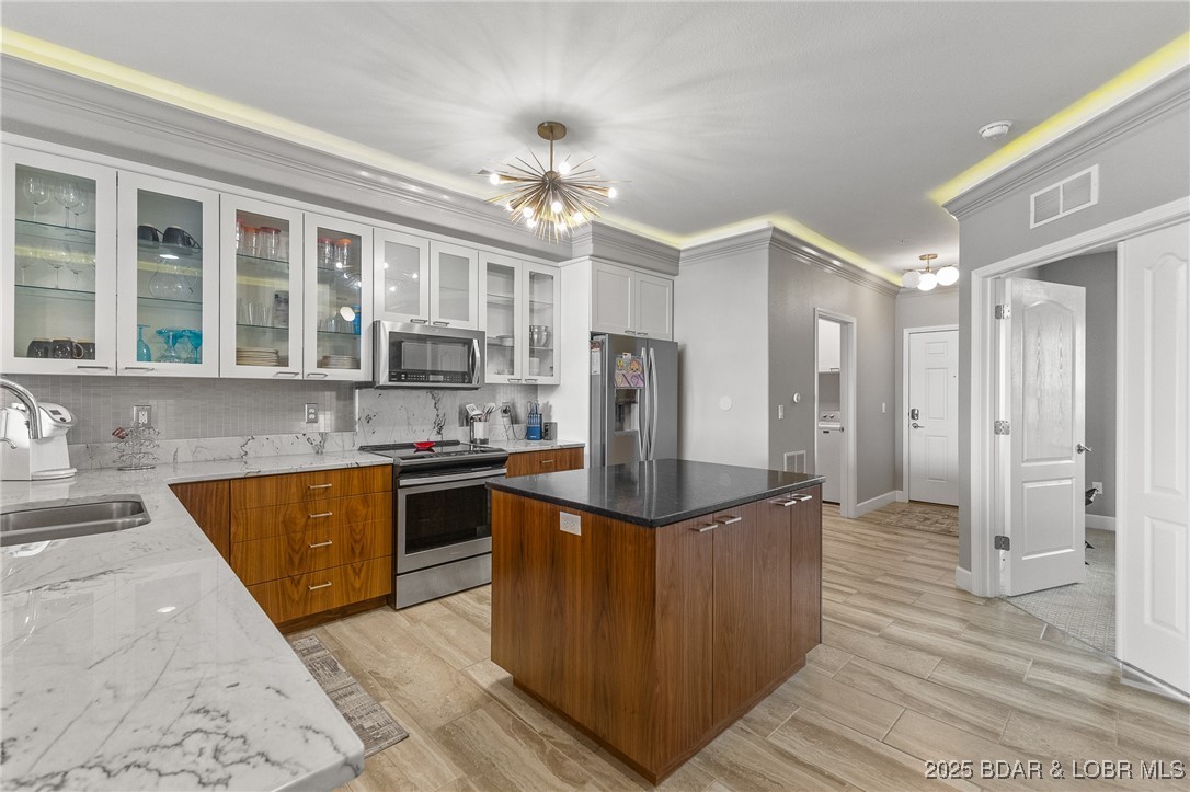 100 Trinity Pointe Drive, Unit 2L Camdenton, MO 65020 - Photo 5 of 43 Cove Lighting, Island, Custom Cabinets