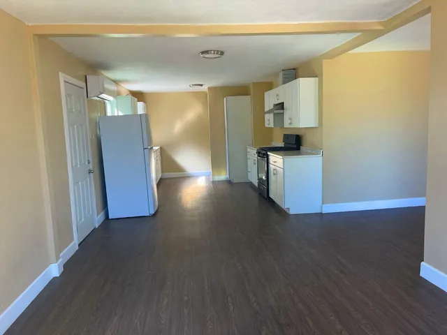 a view of a kitchen cabinets and wooden floor