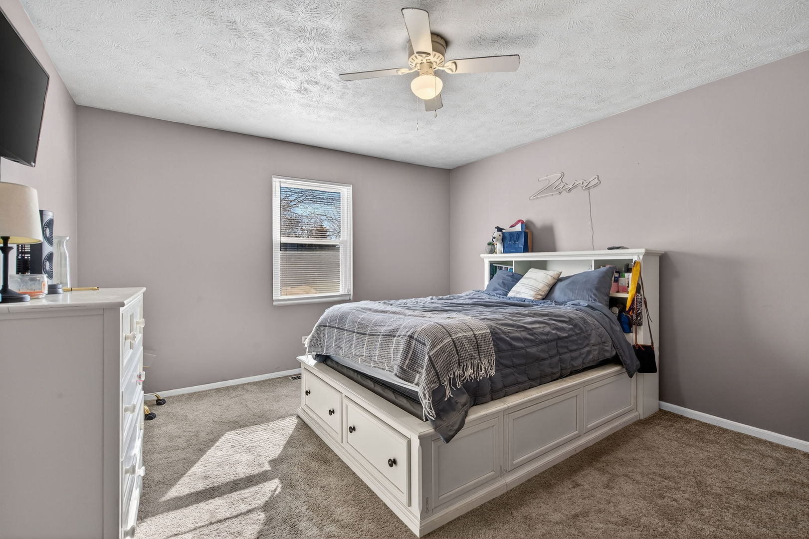 805 Addleman Street Joliet, IL 60431 - Photo 13 of 31 a spacious bedroom with a bed and a chandelier