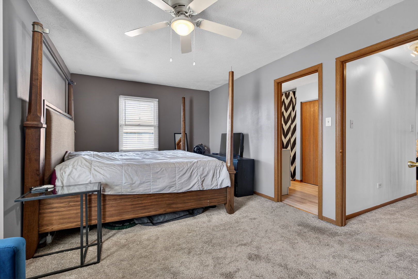805 Addleman Street Joliet, IL 60431 - Photo 14 of 31 a bedroom with a bed and a chandelier