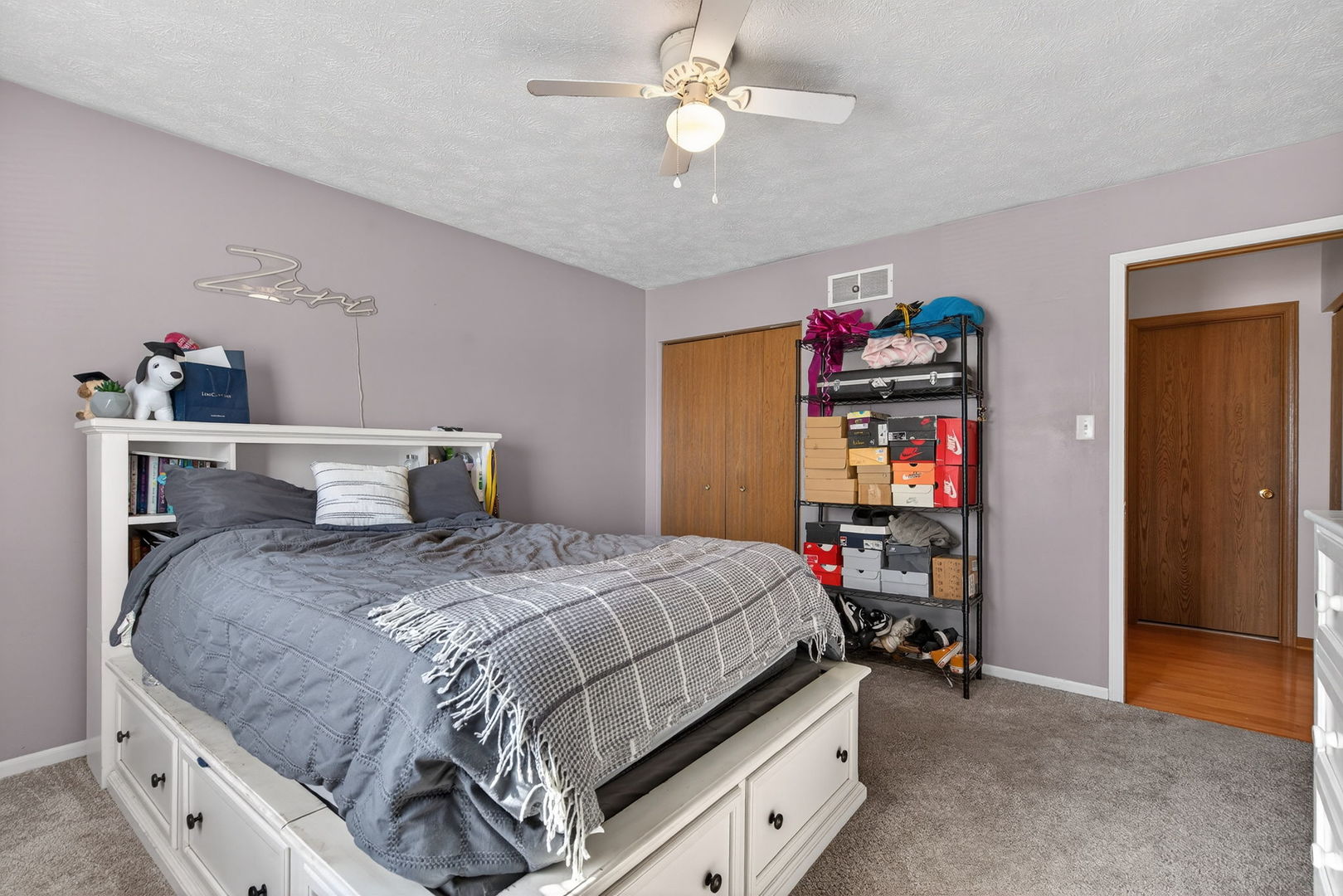 805 Addleman Street Joliet, IL 60431 - Photo 17 of 31 a bedroom with a bed and a chandelier