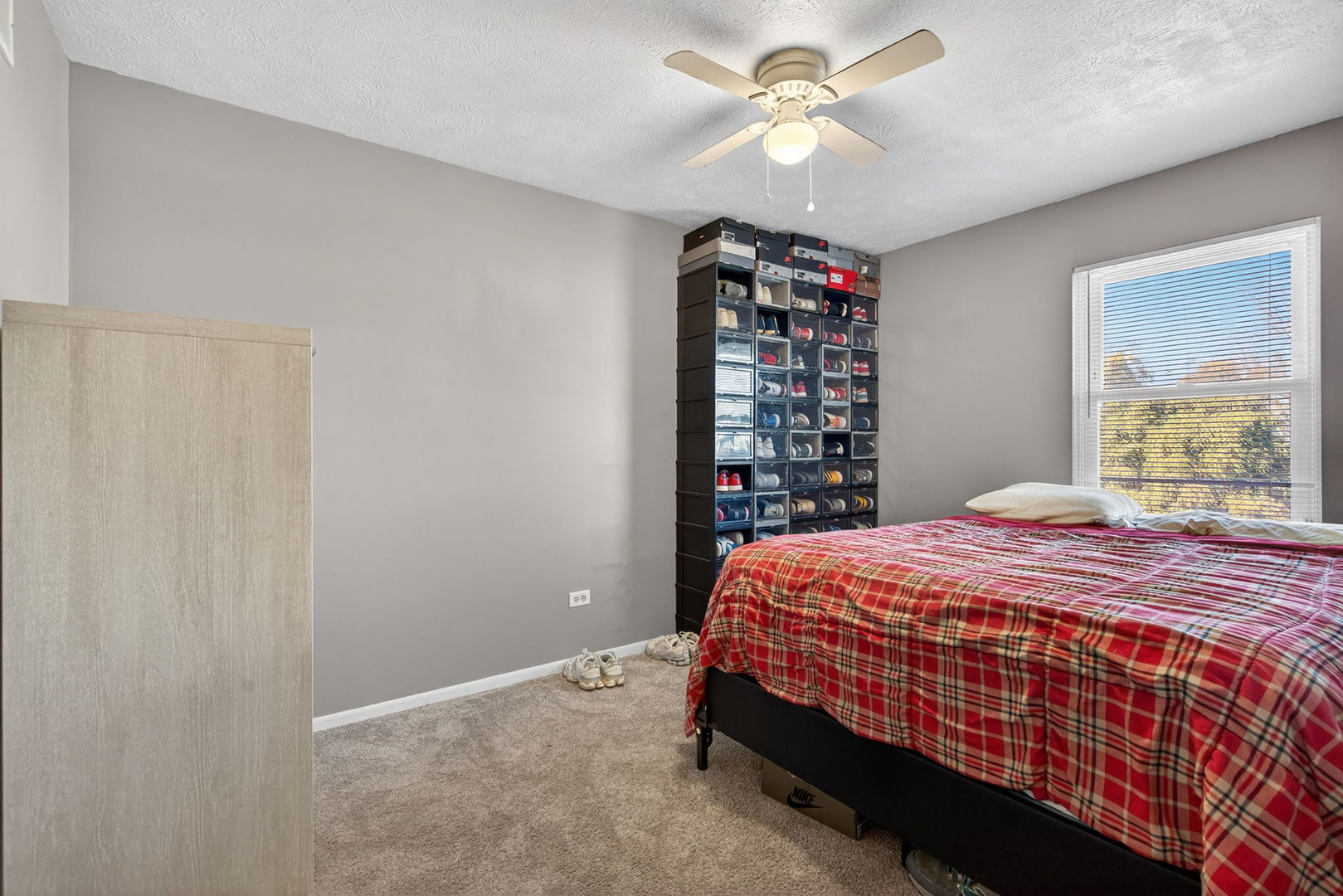 805 Addleman Street Joliet, IL 60431 - Photo 18 of 31 a bedroom with a bed and a chandelier