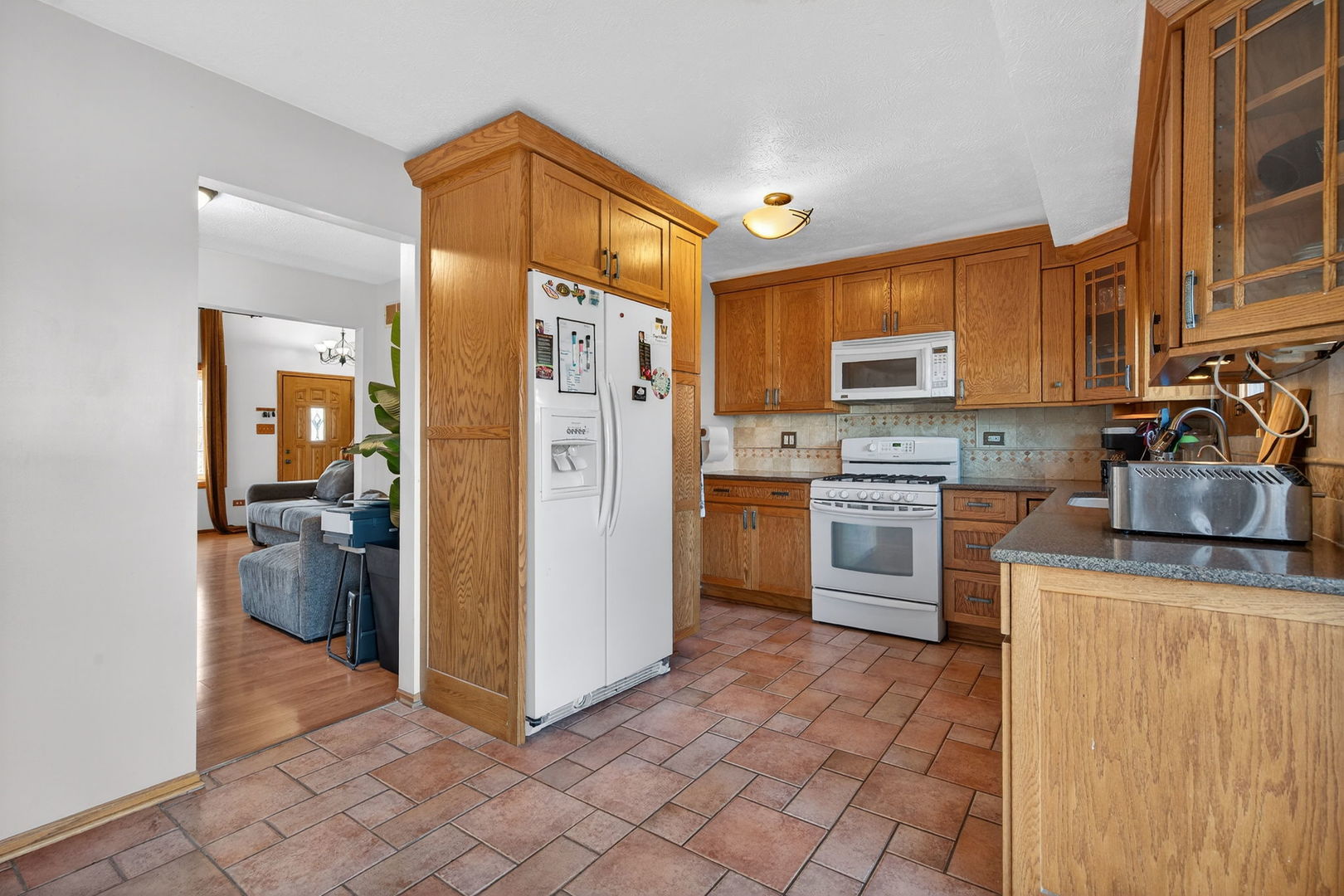 805 Addleman Street Joliet, IL 60431 - Photo 7 of 31 a kitchen with a refrigerator a stove top oven a sink and dishwasher