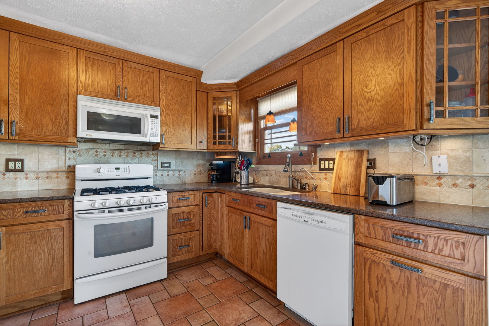 805 Addleman Street Joliet, IL 60431 - Photo 9 of 31 a kitchen with stainless steel appliances granite countertop a stove a sink dishwasher and a microwave oven with cabinets