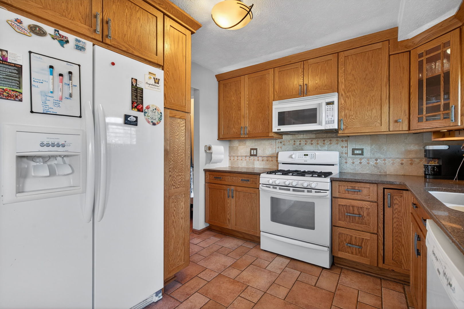 805 Addleman Street Joliet, IL 60431 - Photo 10 of 31 a kitchen with stainless steel appliances granite countertop a refrigerator and a stove top oven