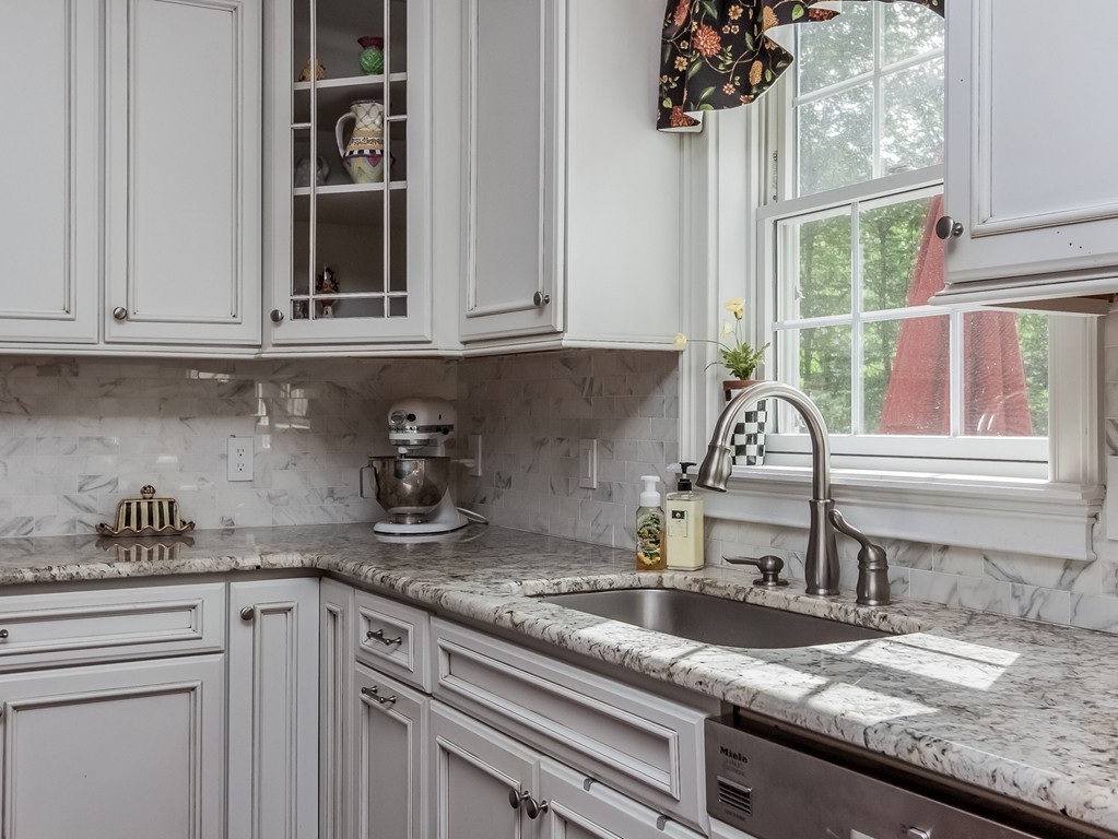 208 Southampton Road Holyoke, MA 01040 - Photo 4 of 30 a kitchen with granite countertop a sink stainless steel appliances and a window