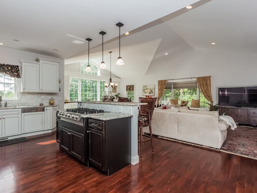 208 Southampton Road Holyoke, MA 01040 - Photo 8 of 30 a kitchen with stainless steel appliances granite countertop wooden floors and white cabinets