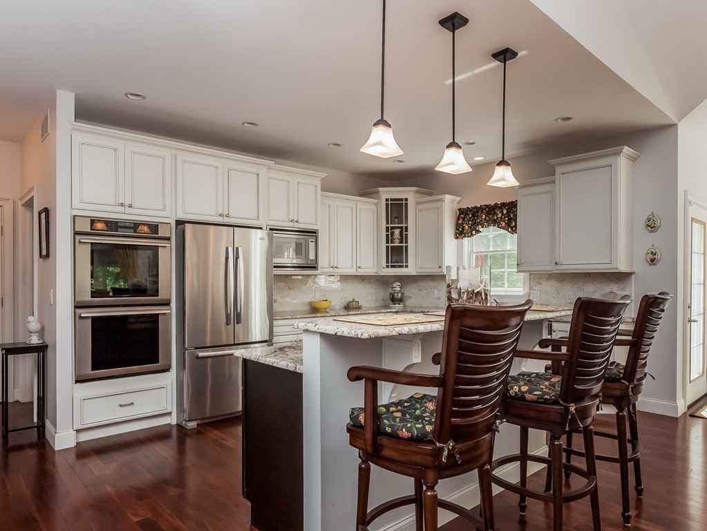 208 Southampton Road Holyoke, MA 01040 - Photo 9 of 30 a kitchen with stainless steel appliances a dining table chairs refrigerator and microwave