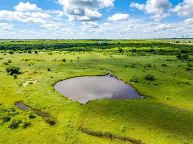 a view of a big yard with lots of green space