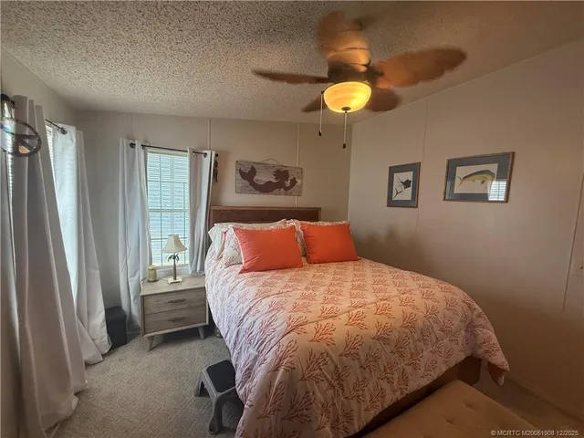a bedroom with a bed and flat screen tv