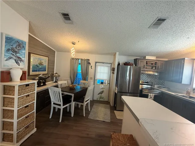 a living room with furniture a flat screen tv and floor to ceiling window