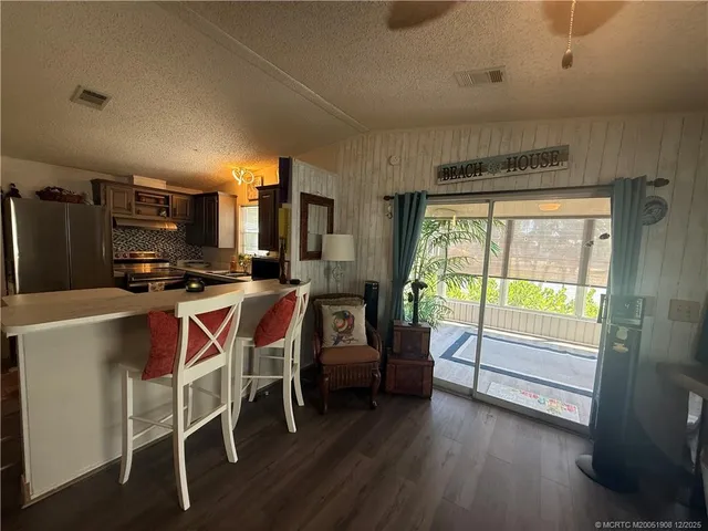a living room with couches and a large window with garden view