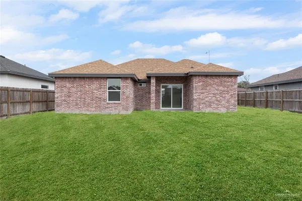 a brick house with a yard