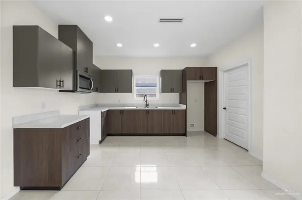 a bathroom with a double vanity sink a mirror and a bathtub