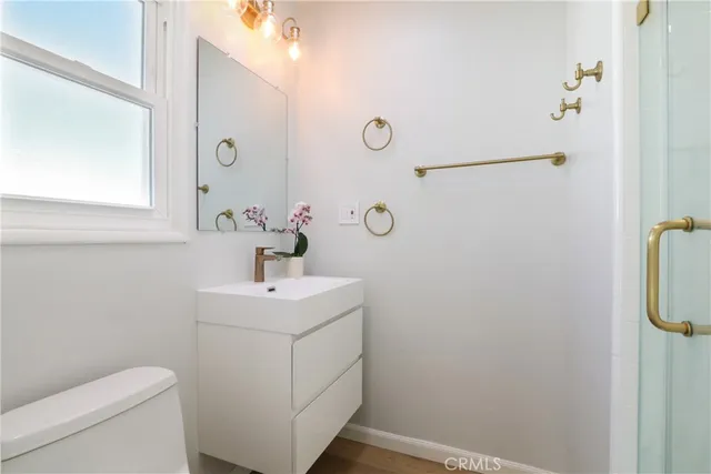 a bathroom with a sink mirror and toilet
