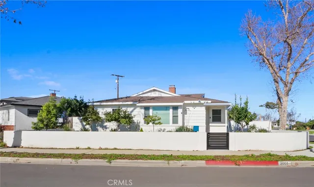 a front view of a house with a yard and fountain