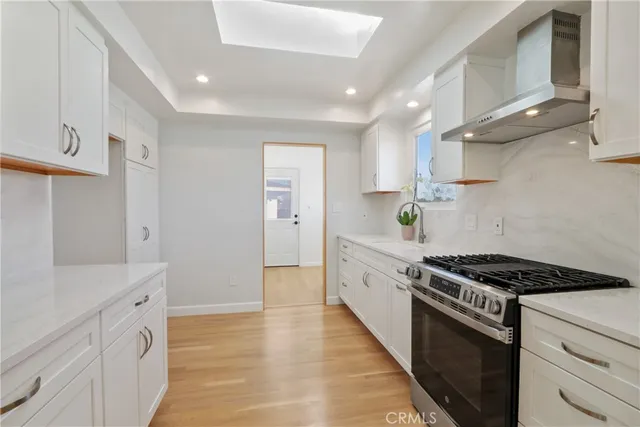 a kitchen with stainless steel appliances a sink dishwasher stove and refrigerator