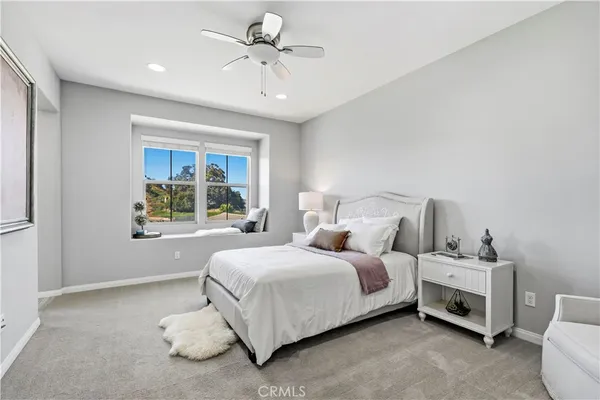 a large bedroom with a bed and a window