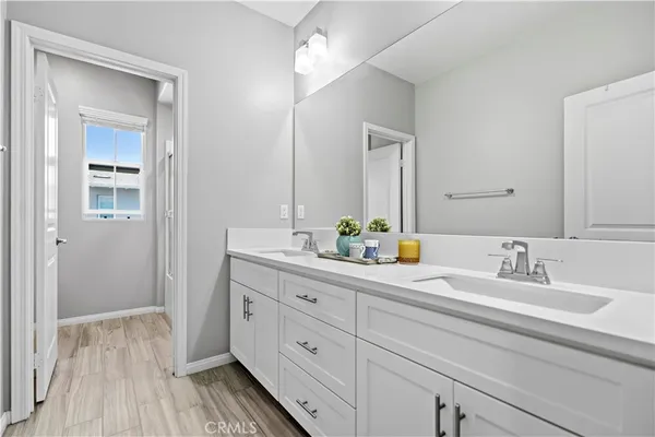 a bathroom with a double vanity sink and mirror