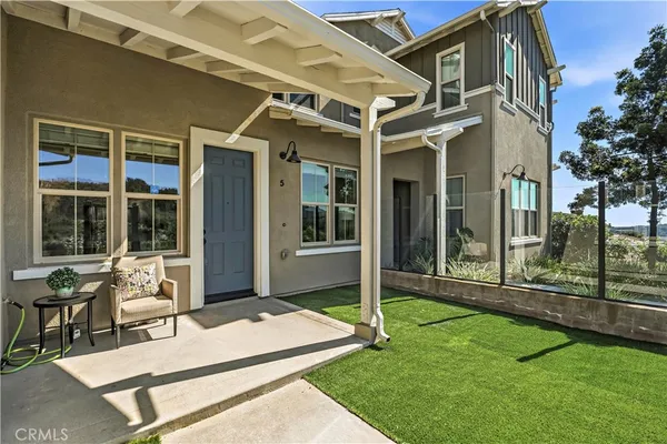 a view of a patio with table and chairs and potted plants