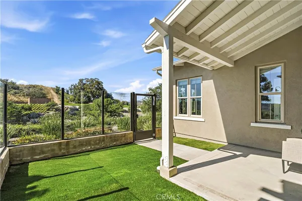 a view of a house with a backyard and balcony