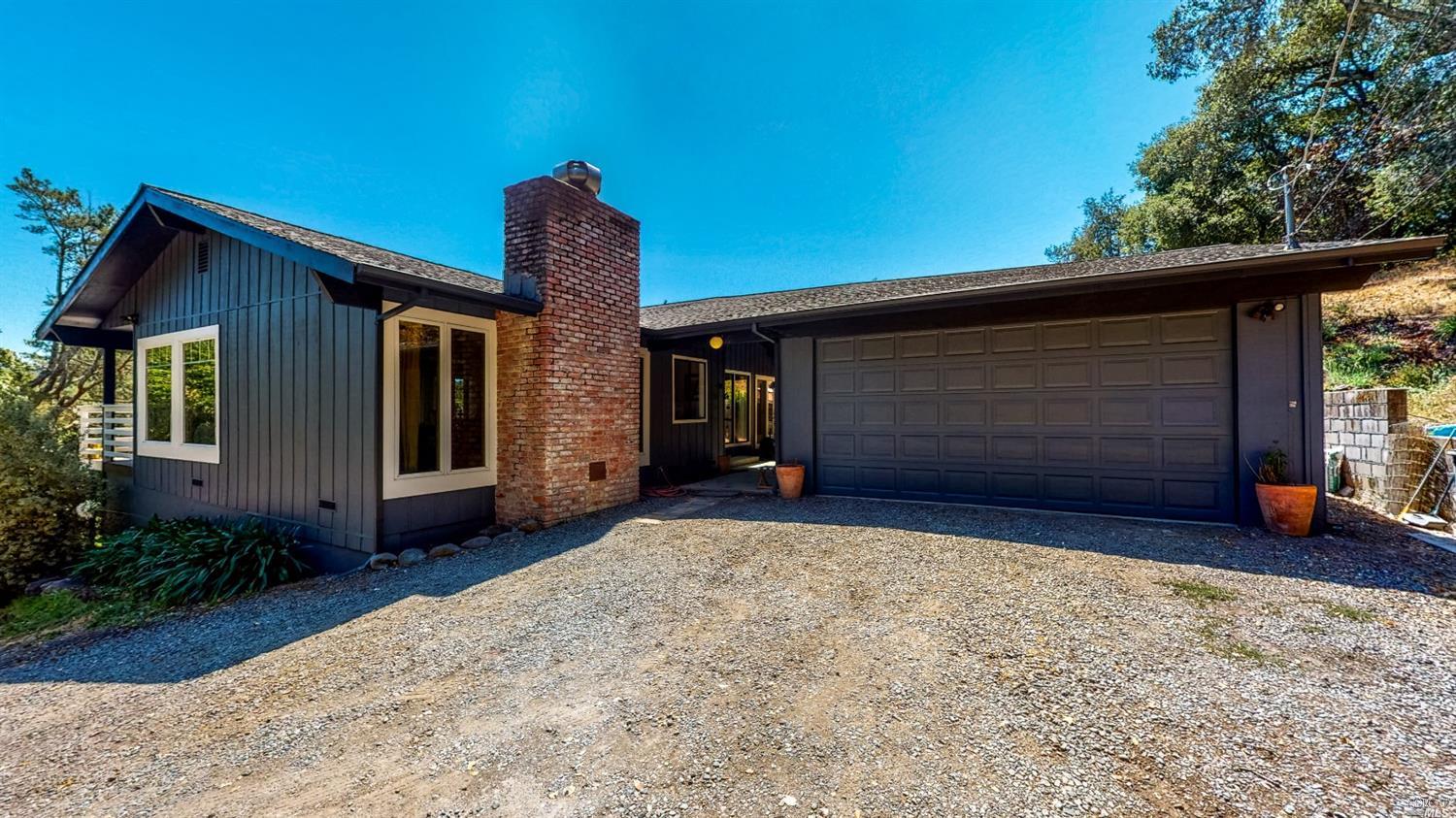 4401 Sonoma Mountain Road Santa Rosa, CA 95404 - Photo 1 of 1 a front view of a house with a yard and garage