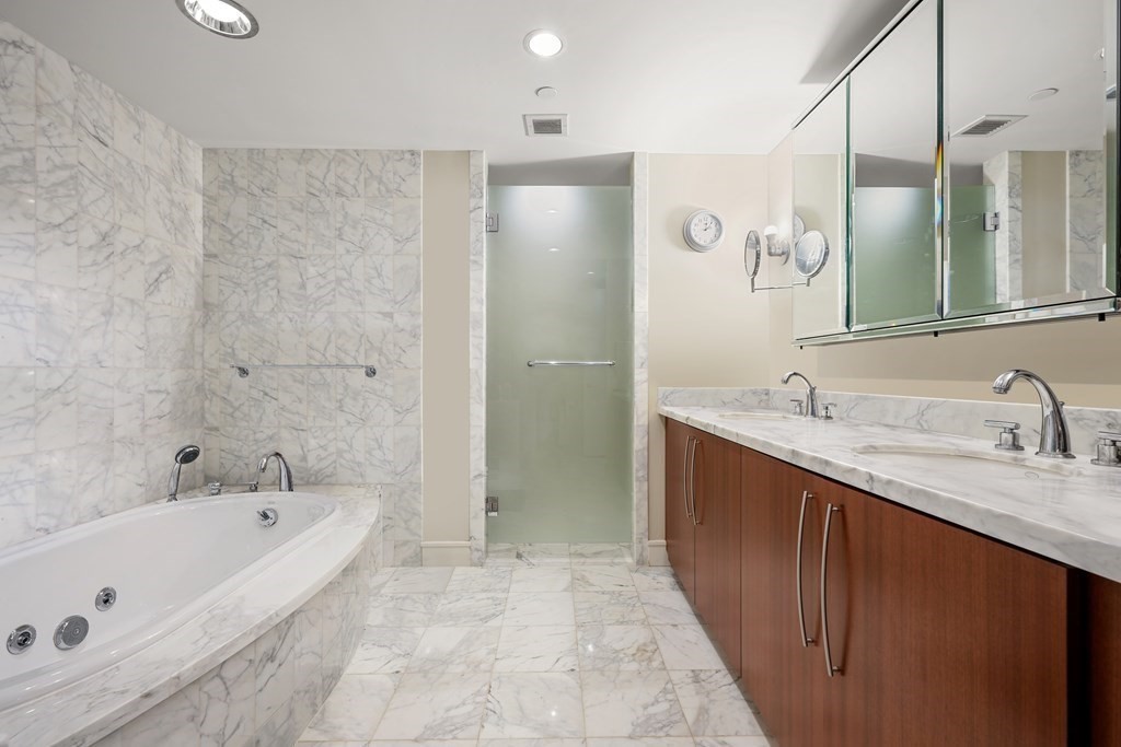 4 Battery Wharf, Unit 4305 Boston, MA 02109 - Photo 5 of 17 a spacious bathroom with a tub sink shower and mirror