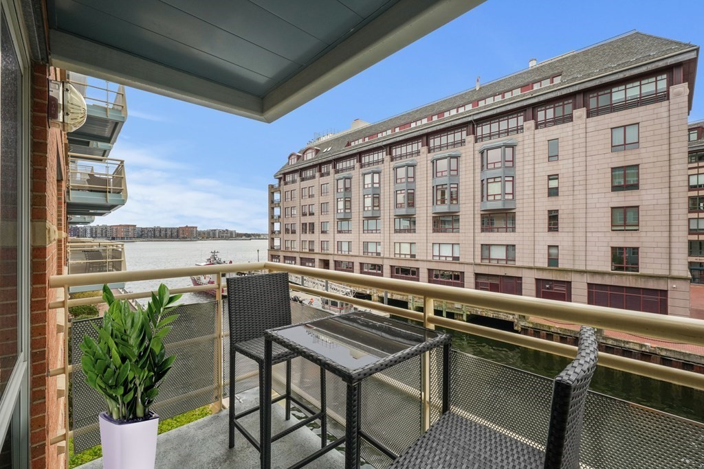 4 Battery Wharf, Unit 4305 Boston, MA 02109 - Photo 6 of 17 a balcony with a table and chairs