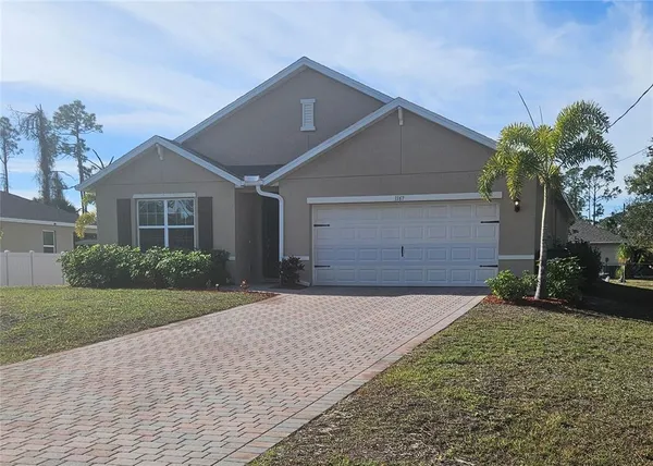 a front view of a house with a yard and a garage