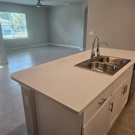 a kitchen with stainless steel appliances granite countertop a sink a refrigerator and a stove