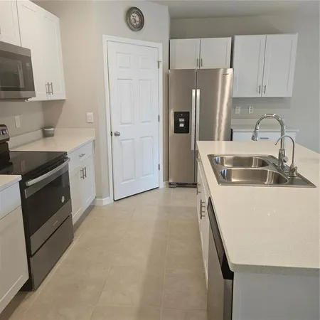 a kitchen with a sink and a stove top oven