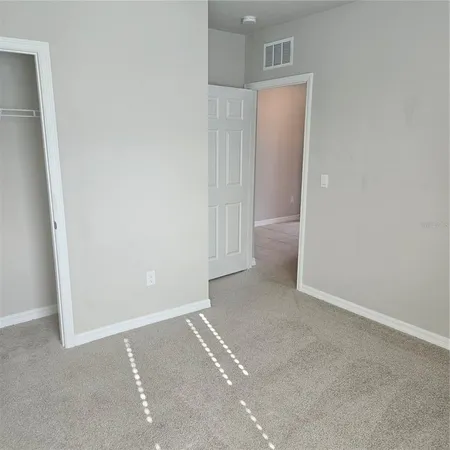 an empty room with closet area